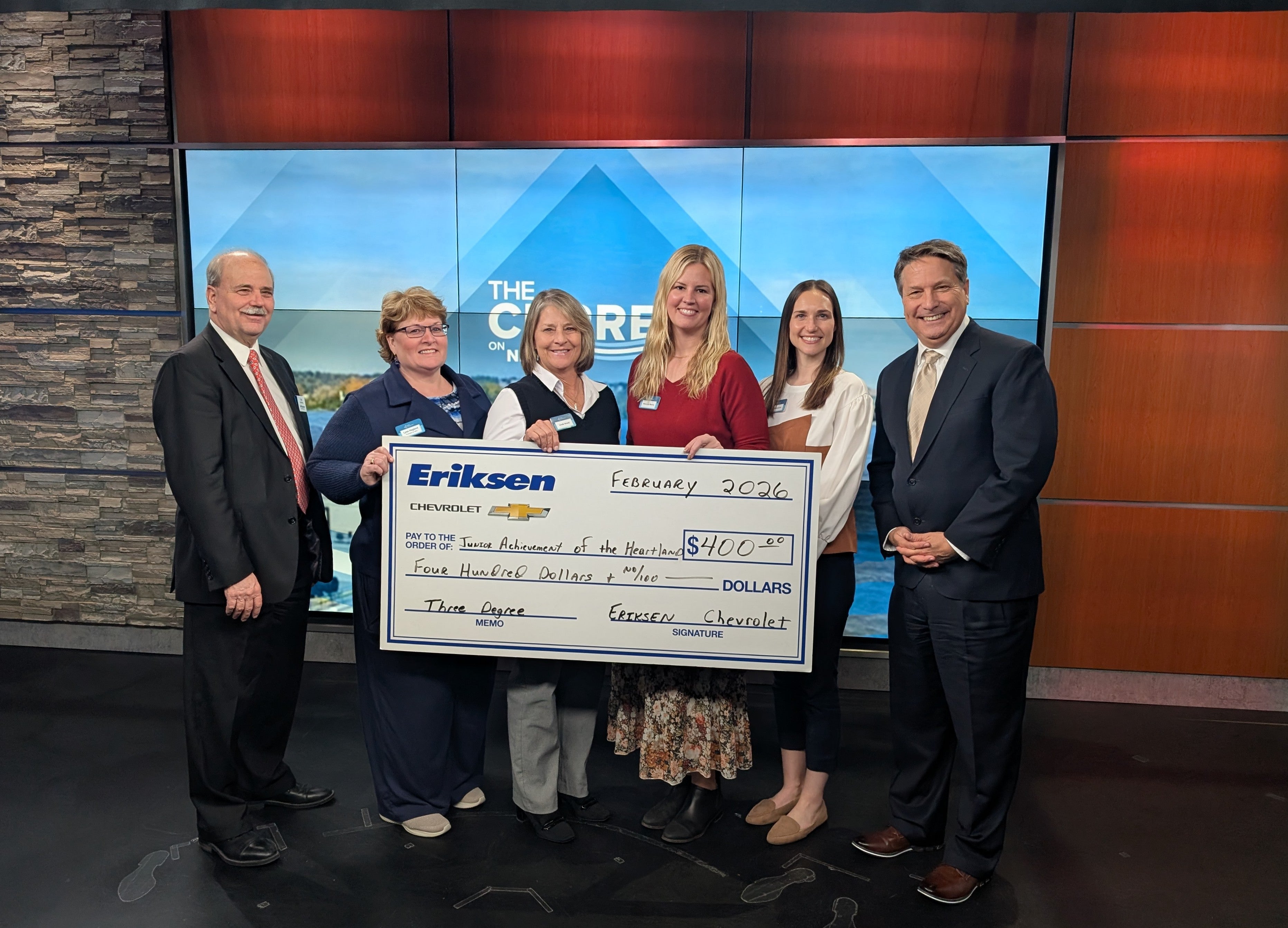 Pictured from left are Tom, are Lysa Hegland, Linda Wood, Makenzie Morris and Katie Sothmann of Junior Achievement of the Heartland with James Zahara.